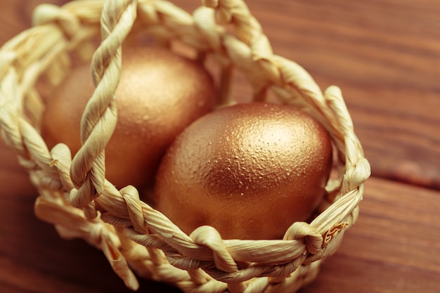Złote jajka na drewnianym stole
