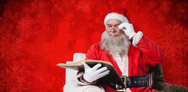 Złożony obraz Świętego Mikołaja czytającego Biblię na fotelu