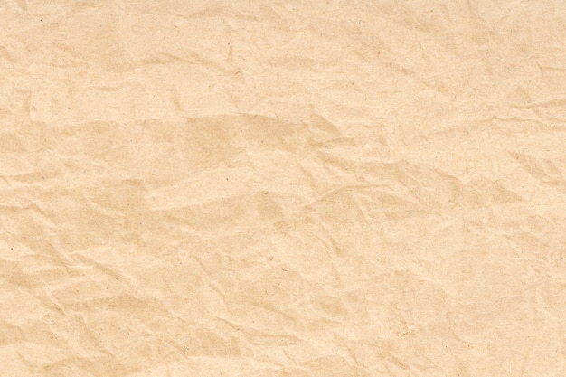 Zmięty papier tekstura tło. Jasnobrązowy kolor