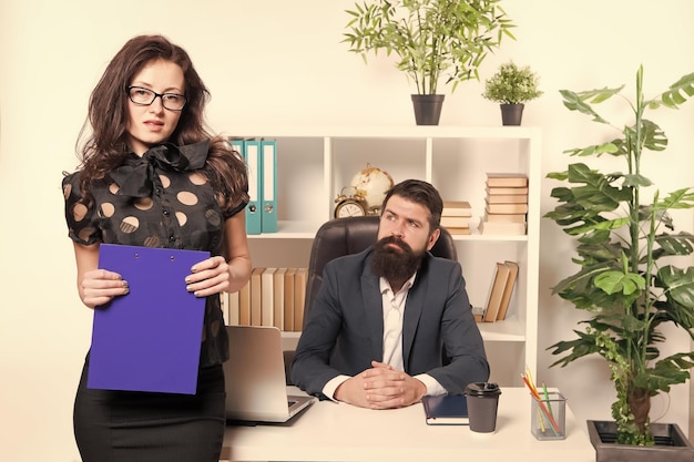 Zmysłowa, ale profesjonalna Zmysłowa biznesowa dama Zmysłowa kobieta stojąca przed biznesmenami w biurze Urocza dziewczyna o zmysłowym wyglądzie trzymająca folder Seksowna sekretarka i jej szef
