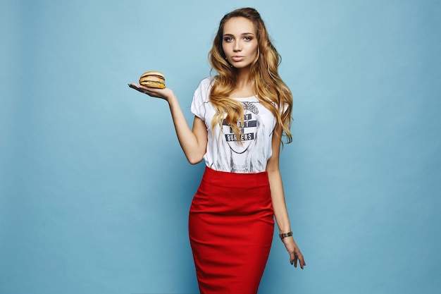 Zmysłowy model w czerwonej spódnicy ze stylową koszulką z burgerem