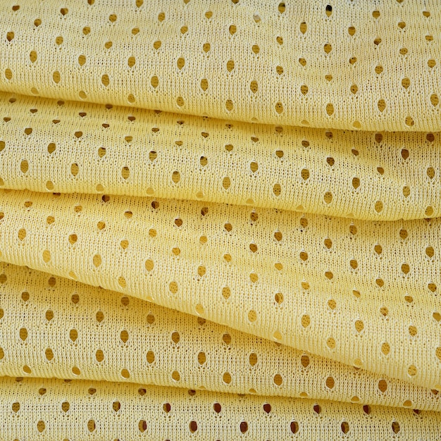 Żółta siatka sportowa odzież tkanina wzór tekstylny tło żółty kolor koszulka piłkarska odzież
