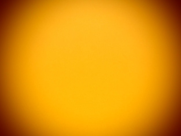 Żółte, żywe abstrakcyjne tło Piękny, bogaty żółty kolor zbliżony do ochry Ciemnopomarańczowe winietowanie wokół krawędzi