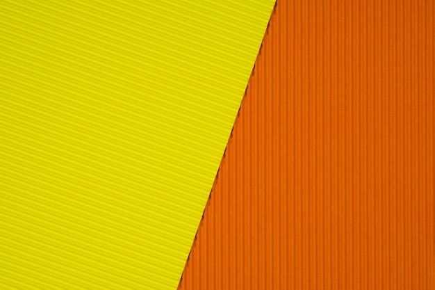 Żółty i pomarańczowy falistej tekstury papieru tło.