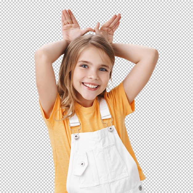 cute lovely charming little girl blond child in tshirt overalls show bunny ears mimicking rabit hold palms behind head smiling joyfully playing acting sweet and tender white wall