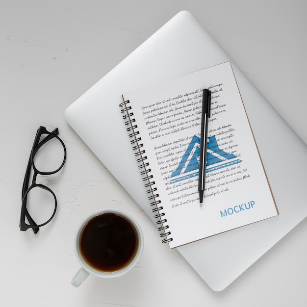 Flat lay of desk surface with laptop and coffee