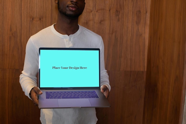 Green Screen Laptop PSD Mockup Held by a Person mockup PSD