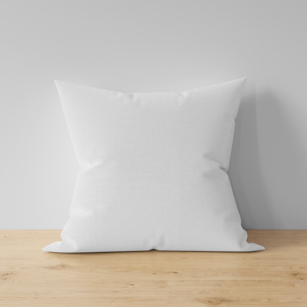 Almohada en blanco sobre mesa de madera