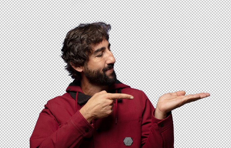 Gratis PSD glimlachend, gelukkig, zorgeloos en tevreden, wijzend naar een concept of idee op de kopieerruimte aan de zijkant