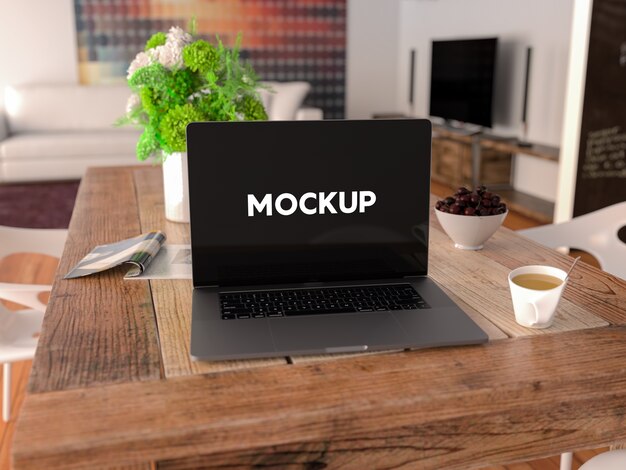 Laptop op een tafel mock up ontwerp