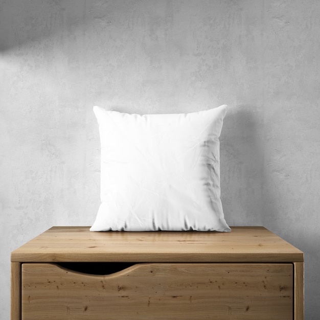 Maqueta de funda de almohada blanca sobre muebles de madera