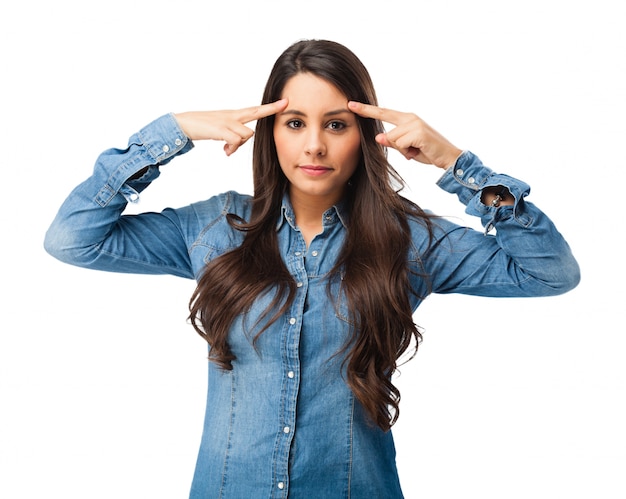 Mujer joven concentrada tocándose la frente