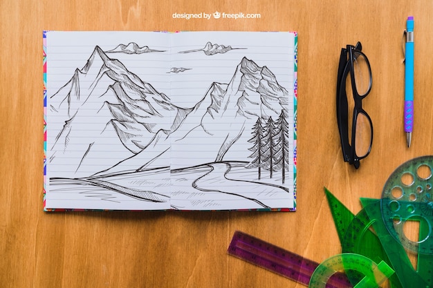 Potlood tekening van bergen met bril, pen en rechte randen