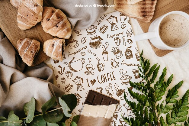 Prima colazione mockup con carta, croissant e tazza