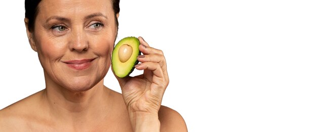 Senior vrouw met avocado voor huidverzorging