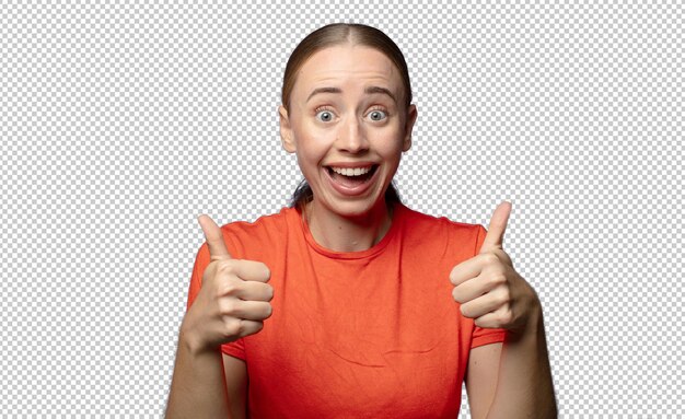 sonriendo alegremente y pareciendo feliz sintiéndose despreocupado y positivo con ambos pulgares hacia arriba