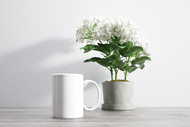 taza de cerámica y flor dentro de maceta