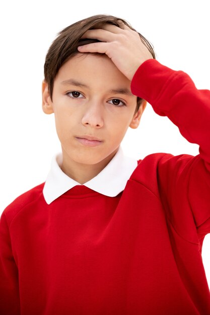 Portrait en studio de jeune garçon avec pull rouge