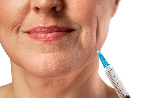 Senior woman avec une seringue pour la peau