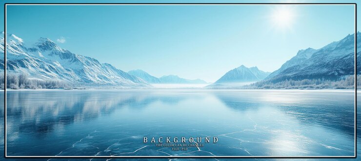 A stunning view of a frozen lake surrounded by snowcapped mountains on a sunny winter day