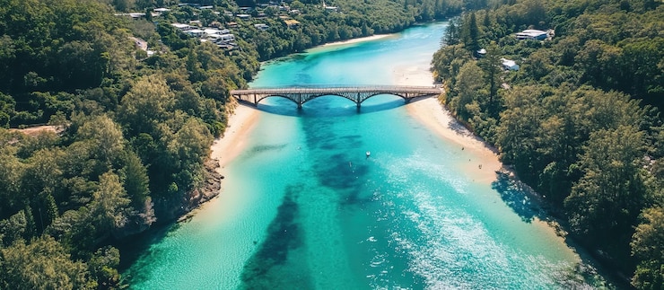 PSD aerial view of a bridge over a turquoise river