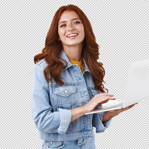 Ambiciosa, entusiasta, guapa, chica líder en vanlife, trabajando a distancia, de pie sobre fondo blanco, elegante chaqueta de mezclilla, sostenga una computadora portátil, sonriendo, satisfecha, trabajando independientemente, escribiendo un ensayo universitario.
