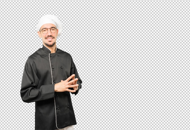 Amichevole giovane chef facendo un gesto di fiducia