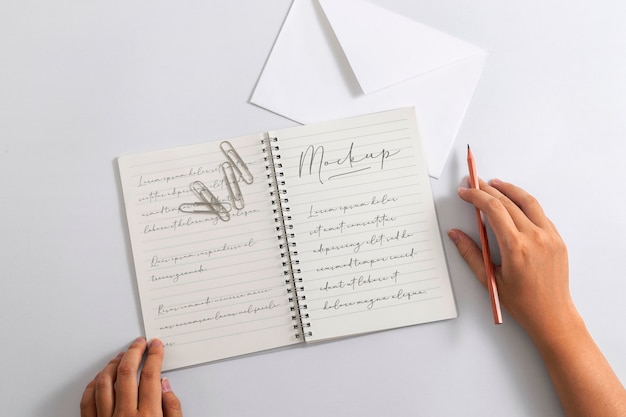 Ansicht einer Person, die mit Bleistift auf Papier schreibt