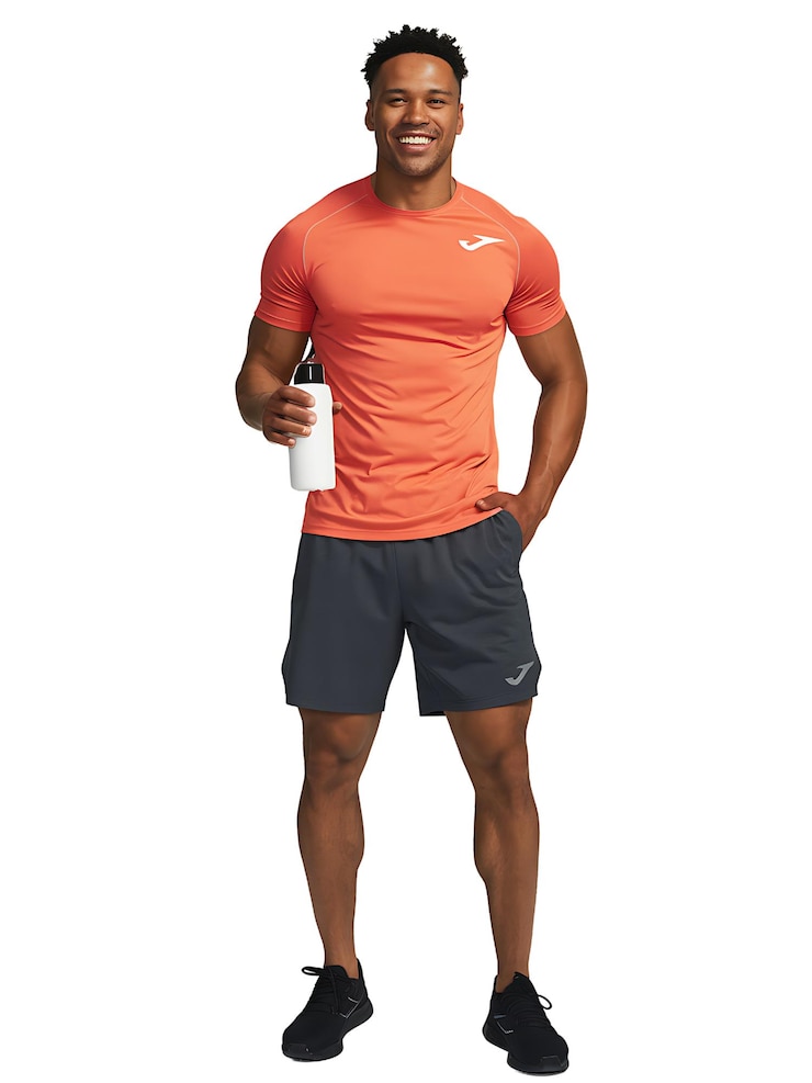 PSD un athlète confiant en chemise et shorts orange vif