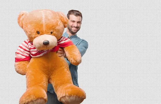 Beau jeune homme avec un ours en peluche