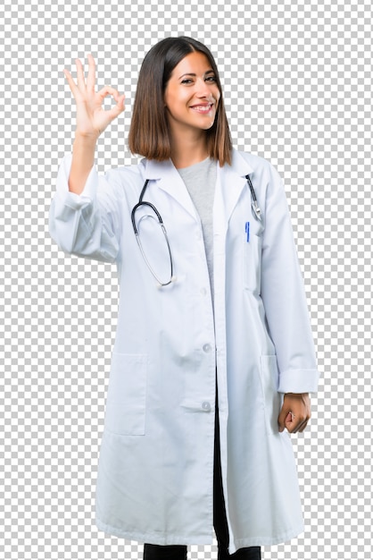 Behandeln Sie Frau mit dem Stethoskop, das ein okayzeichen mit den Fingern zeigt. Gesicht des Glücks und der Zufriedenheit