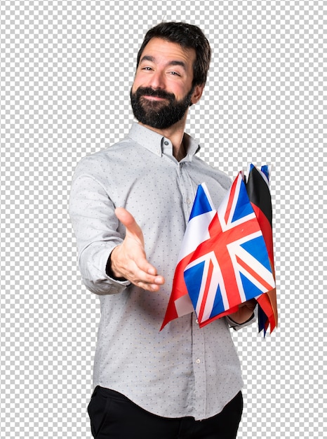 Bel homme à la barbe tenant beaucoup de drapeaux et faisant une affaire