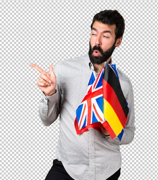 PSD bel homme à la barbe tenant beaucoup de drapeaux et pointant vers le côté