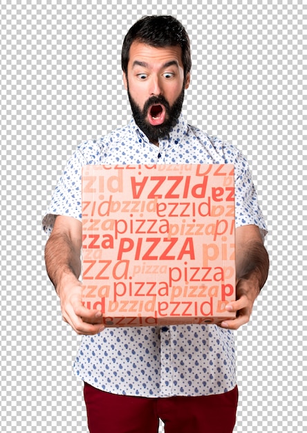 Bel homme brune à la barbe tenant une pizza