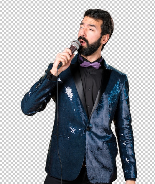 Bel homme avec une veste à paillettes chantant avec microphone