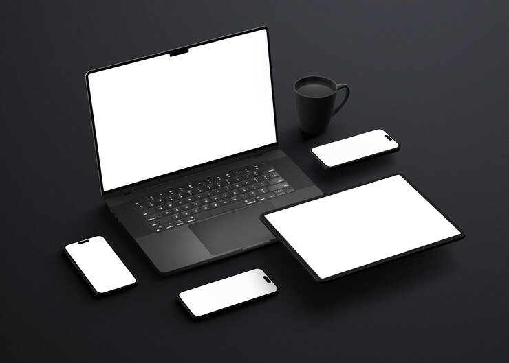 PSD black laptop smartphone tablet and mug on a dark surface