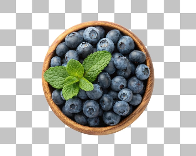 Un bol en bois de bleuets frais avec quelques feuilles de menthe isolées sur un fond transparent