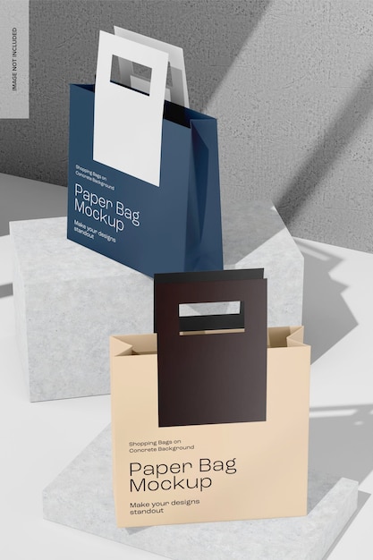 Bolsas de papel en el fondo de hormigón Mockup vista en ángulo alto