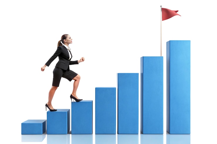 PSD businesswoman in a climbing a blue bar graph with a flag at the top isolated on a white background
