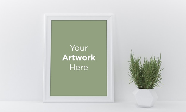 Cadre photo vide Mockup Design sur mur blanc avec vase et plante