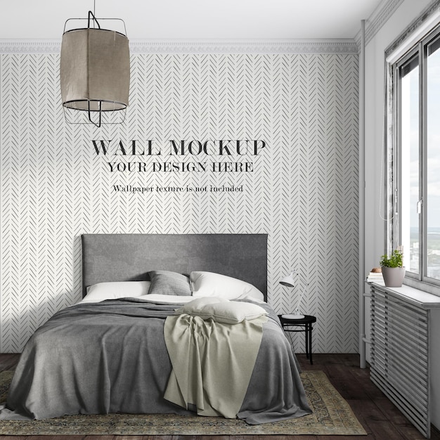 Cama cinza em frente ao design de maquete de parede