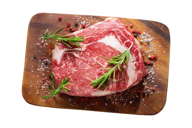 carne fresca con rosmarino e spezie su una tavola di legno isolata su uno sfondo trasparente vista dall'alto
