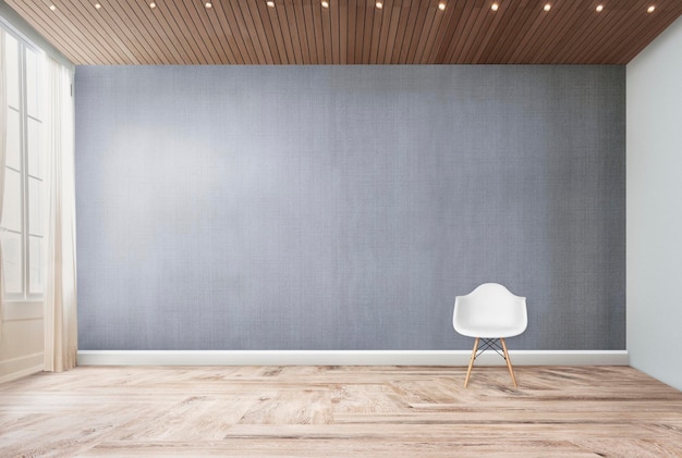 Une chaise blanche contre une maquette de mur gris