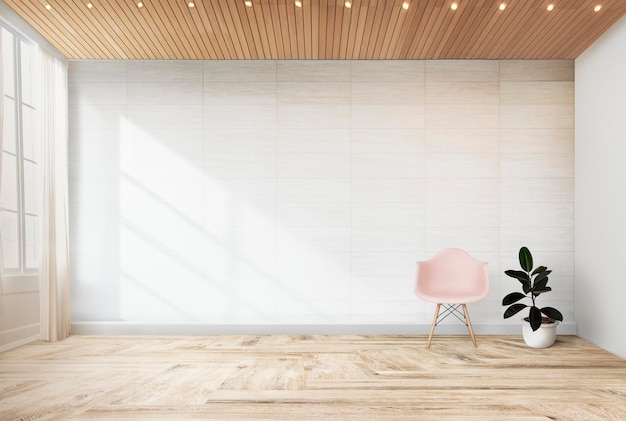 Une chaise rose et une plante contre une maquette de mur