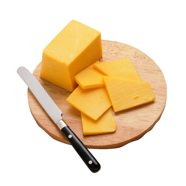 PSD cheddar cheese slices on a wooden board with a knife