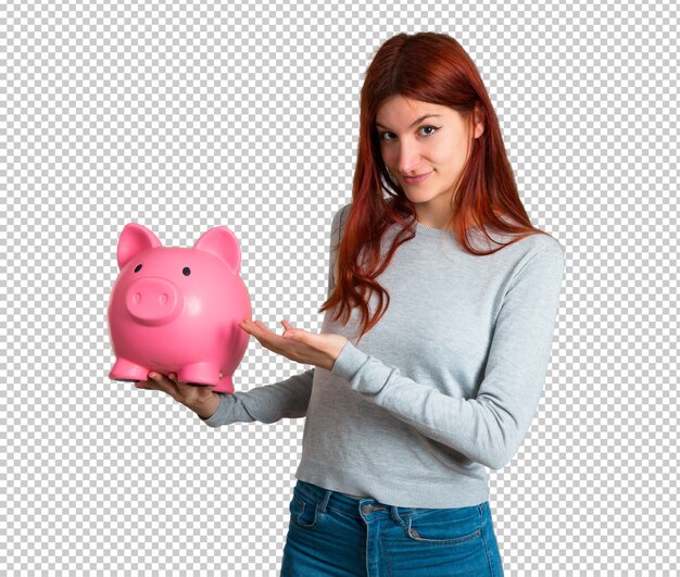 PSD chica pelirroja joven sosteniendo un gran piggybank