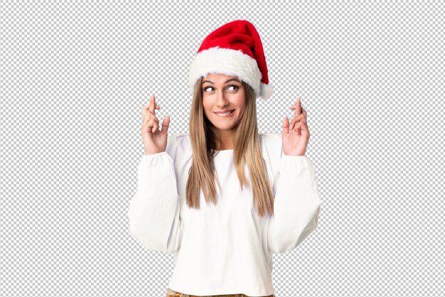 Chica rubia con sombrero de navidad con cruzar los dedos