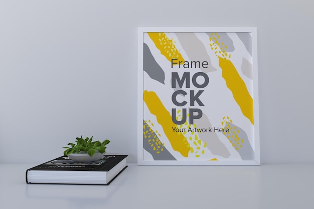 Close de uma maquete de moldura branca com um livro na estante