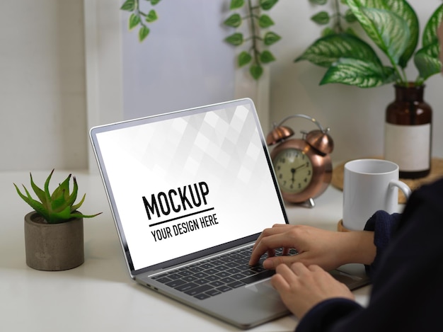close up view of female hands typing on laptop mockup
