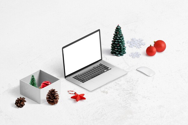 PSD compras en línea para el concepto de regalos de navidad. maqueta de portátil, caja de regalo y decoraciones al lado.